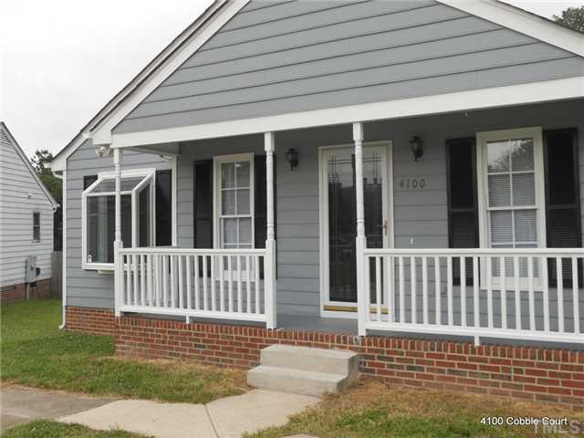 4100 Cobble Court Raleigh, NC 27616 - Photo 2 of 21 a porch area with a table and chairs
