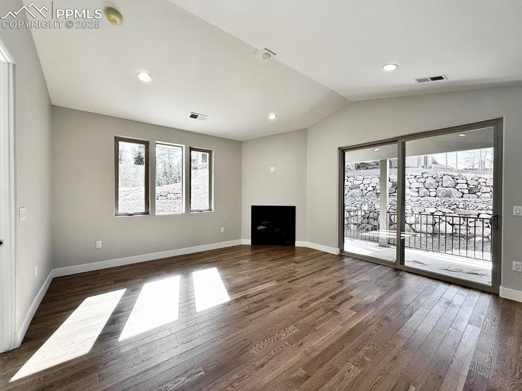 3155 Promise Point Colorado Springs, CO 80921 - Photo 15 of 26 a view of an empty room with wooden floor and a window