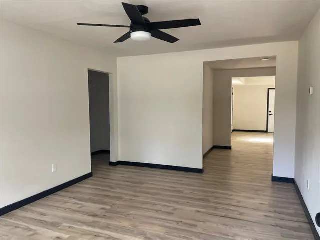 a view of an empty room and wooden floor