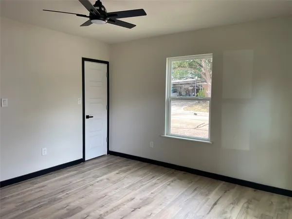 wooden floor in an empty room with a window