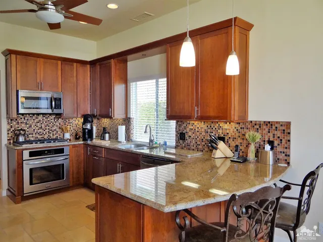 a kitchen with a sink cabinets and window