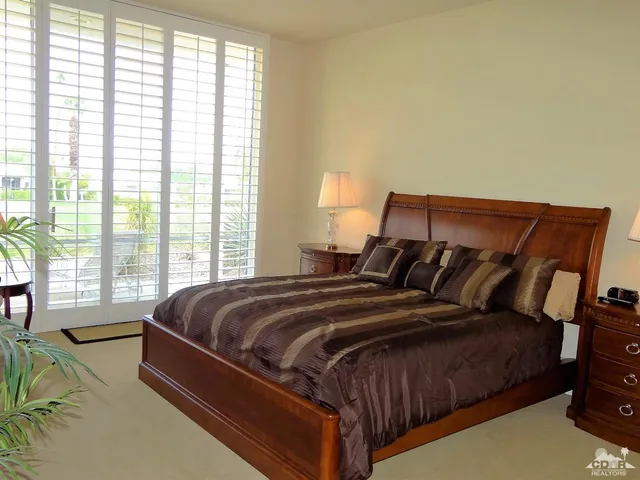 a bed sitting in a bedroom next to a window