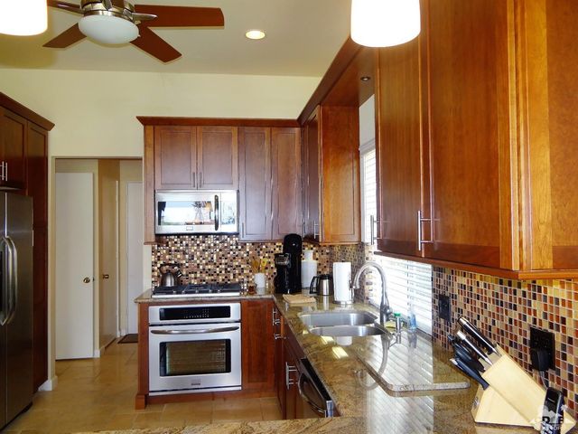 a kitchen with stainless steel appliances a stove and a refrigerator