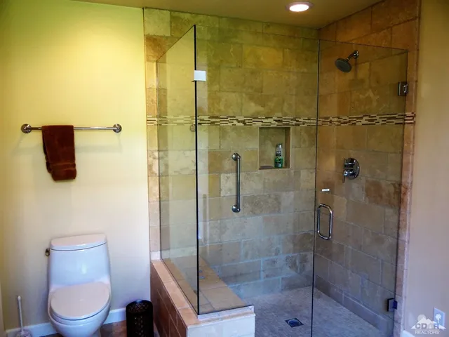 a bathroom with a shower a toilet and sink