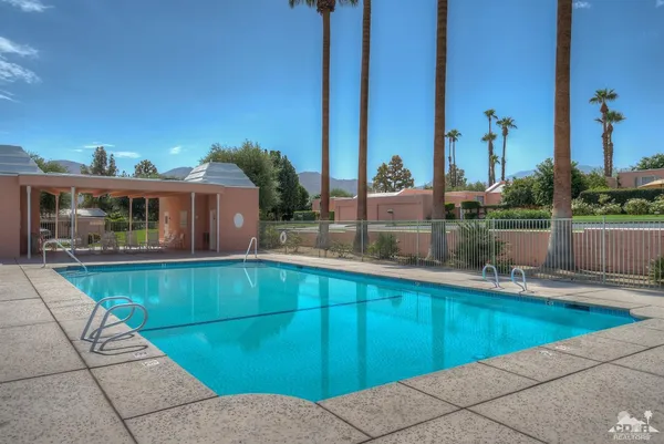 a view of a swimming pool with a lounge chairs