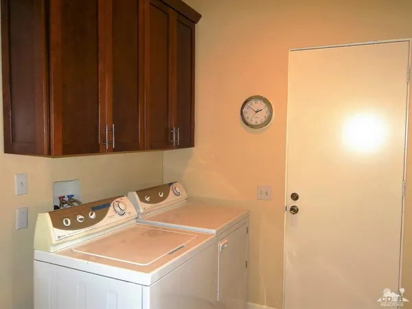 a view of bathroom with a sink and cabinets