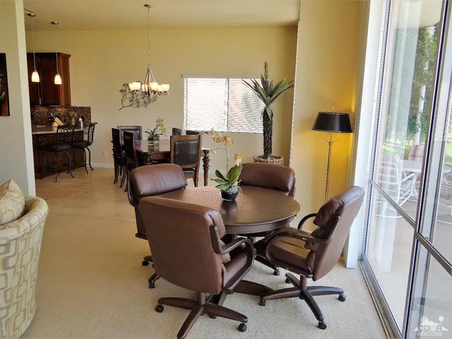 a dining room with furniture and window