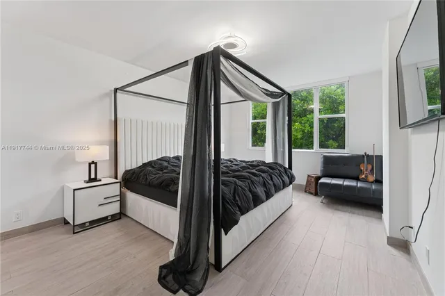 a bedroom with a bed and a window