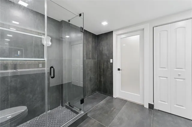 a bathroom with a glass shower door