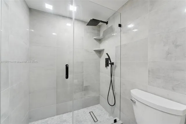 a bathroom with a shower and toilet