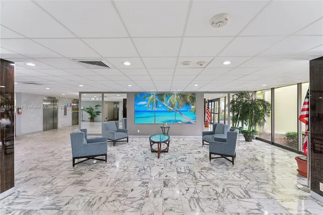 a living room with patio furniture and a flat screen tv