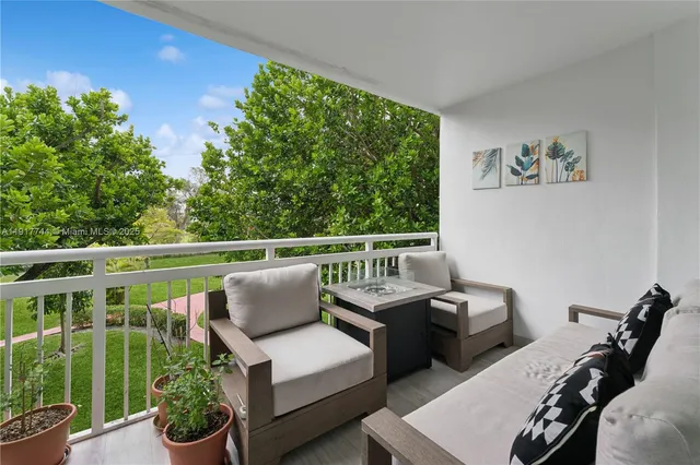 a balcony with furniture and potted plants