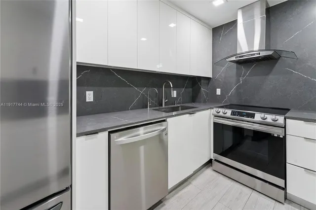 a kitchen with granite countertop a stove and a sink