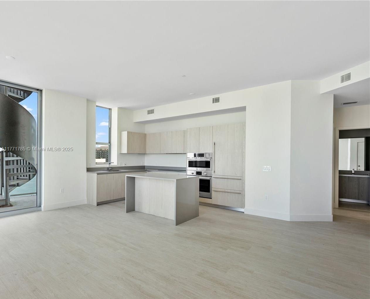 4010 South Ocean Drive, Unit T4301 Hollywood, FL 33019 - Photo 4 of 10 a kitchen with a refrigerator and white cabinets