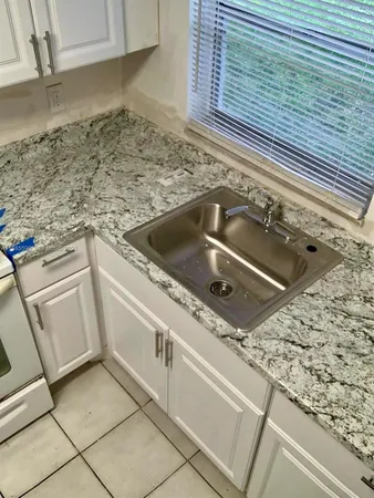 a kitchen with a sink and a stove
