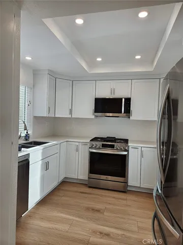 a kitchen with stainless steel appliances a stove a sink and a microwave