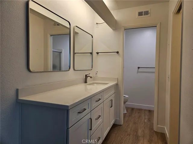 a bathroom with a sink a light fixture a vanity and a mirror