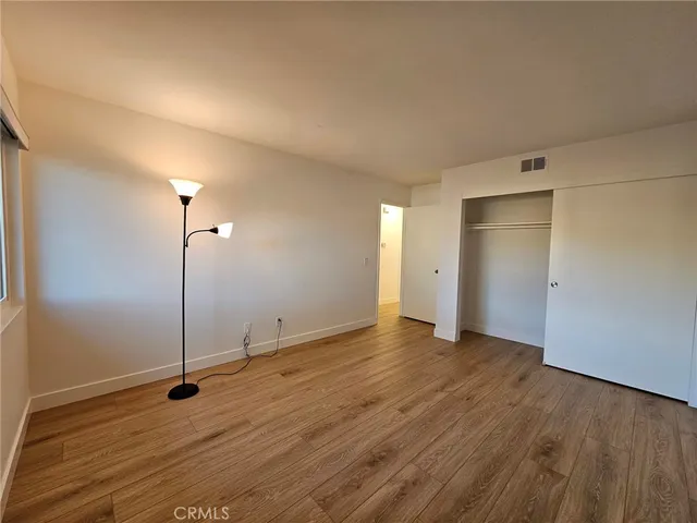 a view of a room with wooden floor