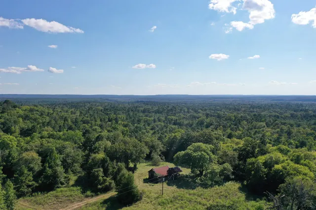 a view of a big yard with an ocean view