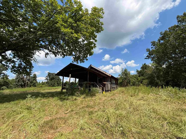a backyard of a house with yard barbeque oven and outdoor seating