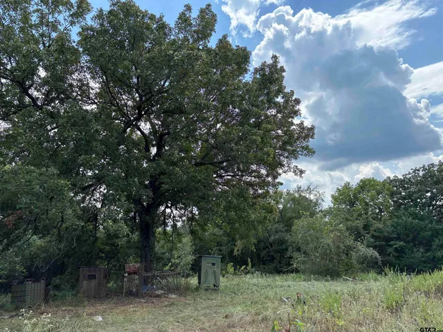 a view of a street sign of a house next to a yard