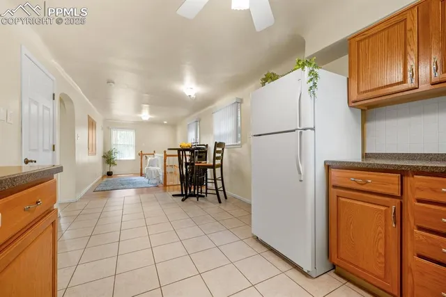 a view of kitchen with furniture and refrigerator