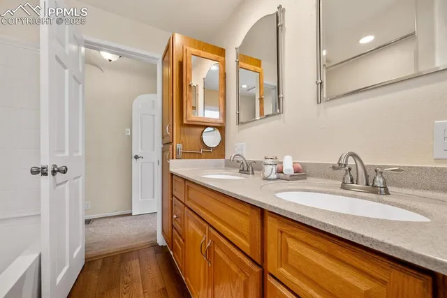 a bathroom with a granite countertop sink mirror and double