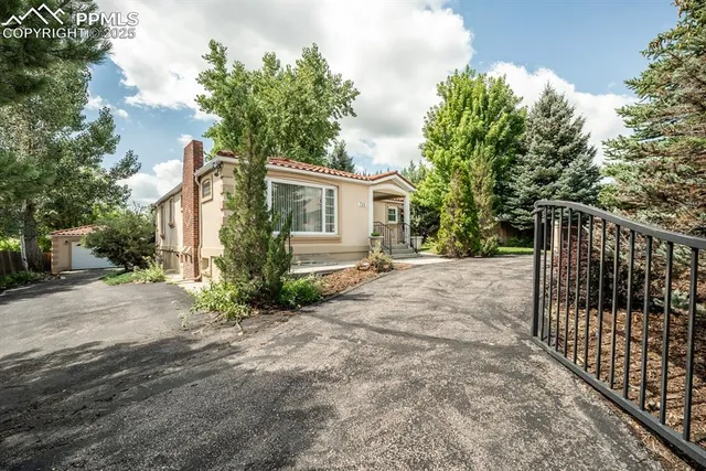 a view of a house with a wooden fence