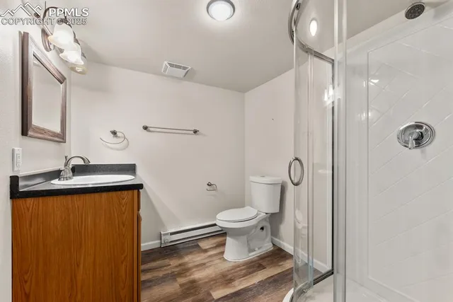 a bathroom with a granite countertop sink toilet and shower