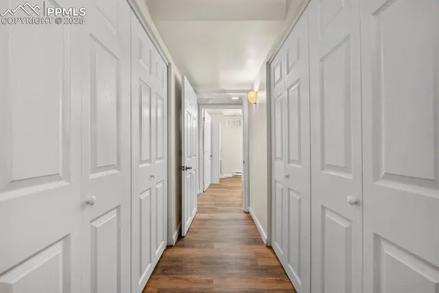 a view of a hallway with a wooden door