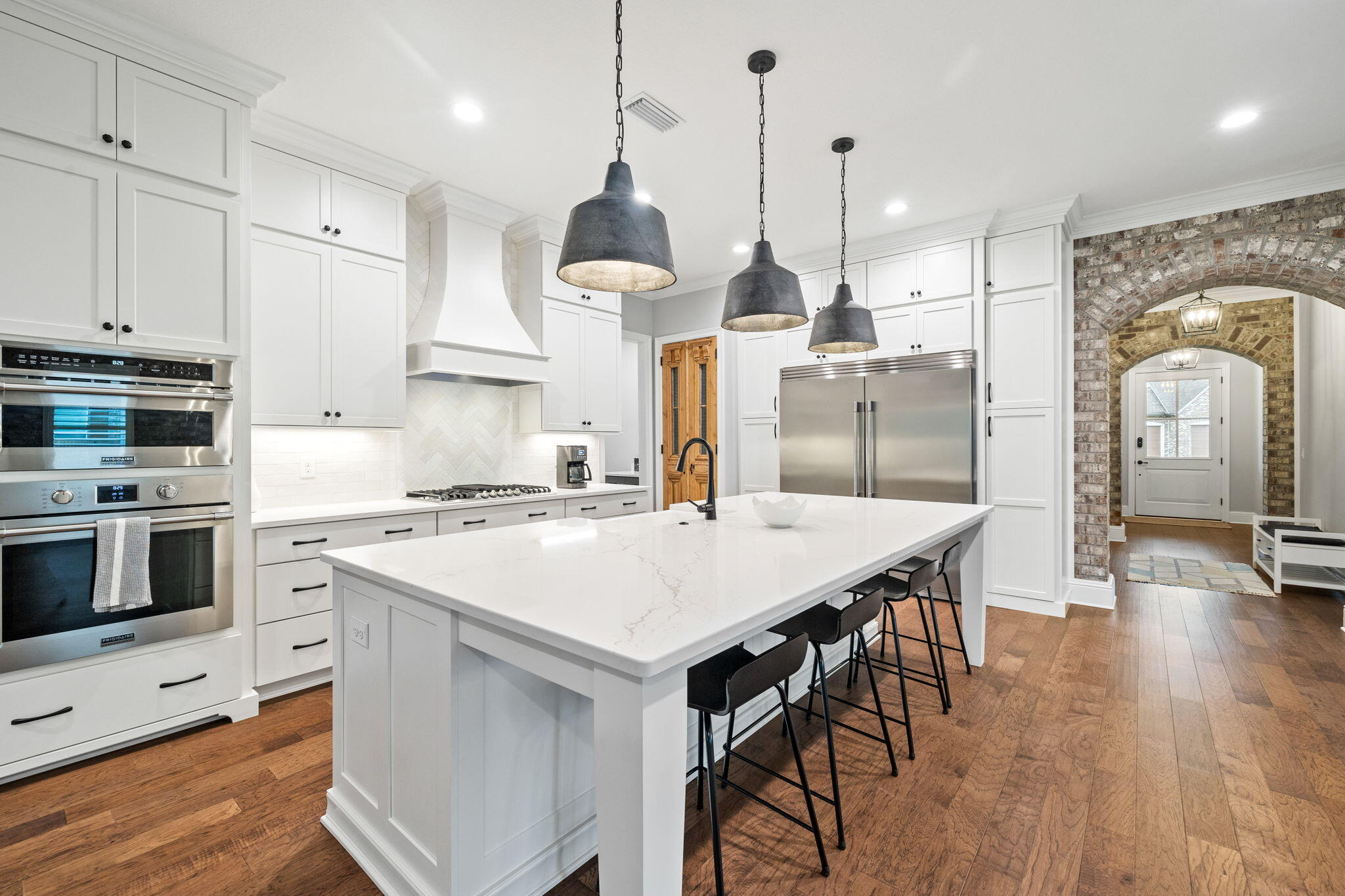92 Revana Way Freeport, FL 32439 - Photo 36 of 59 a kitchen with stainless steel appliances a stove a sink a oven a refrigerator and white cabinets with wooden floor