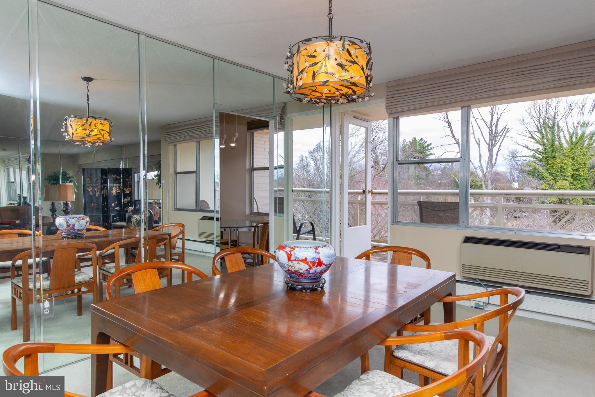 7900 Old York Road, Unit 906A Elkins Park, PA 19027 - Photo 17 of 42 a view of a dining room with furniture a chandelier and large windows