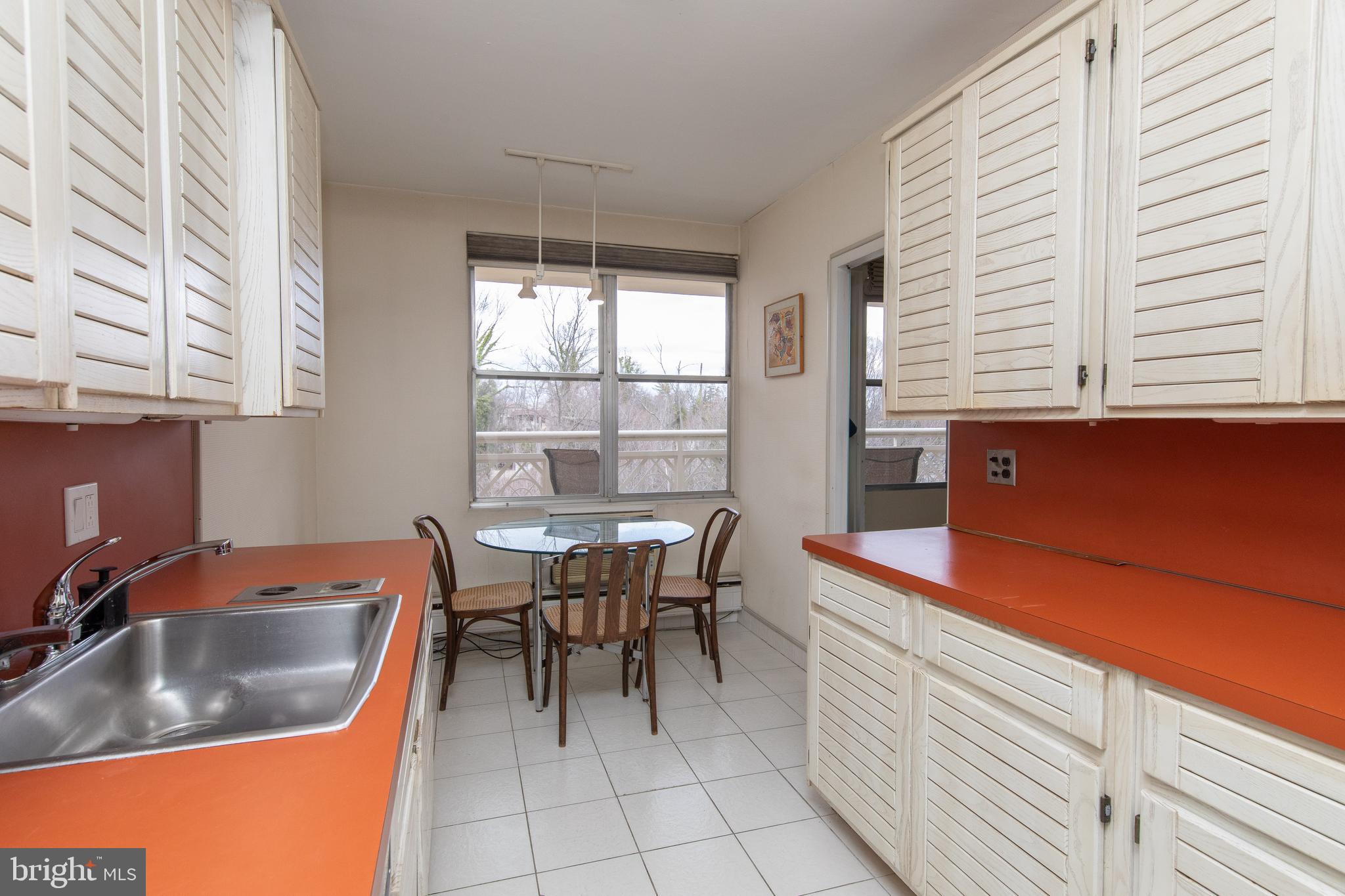 7900 Old York Road, Unit 906A Elkins Park, PA 19027 - Photo 20 of 42 a kitchen with a sink cabinets and window