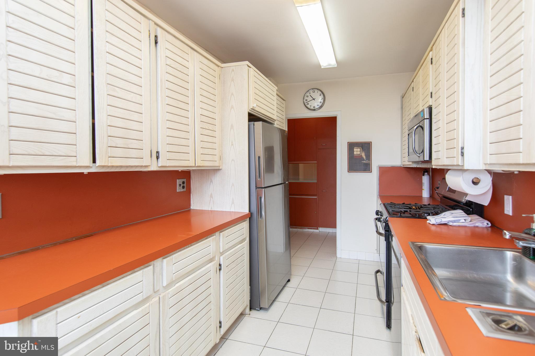 7900 Old York Road, Unit 906A Elkins Park, PA 19027 - Photo 21 of 42 a kitchen with stainless steel appliances granite countertop a refrigerator and a stove top oven