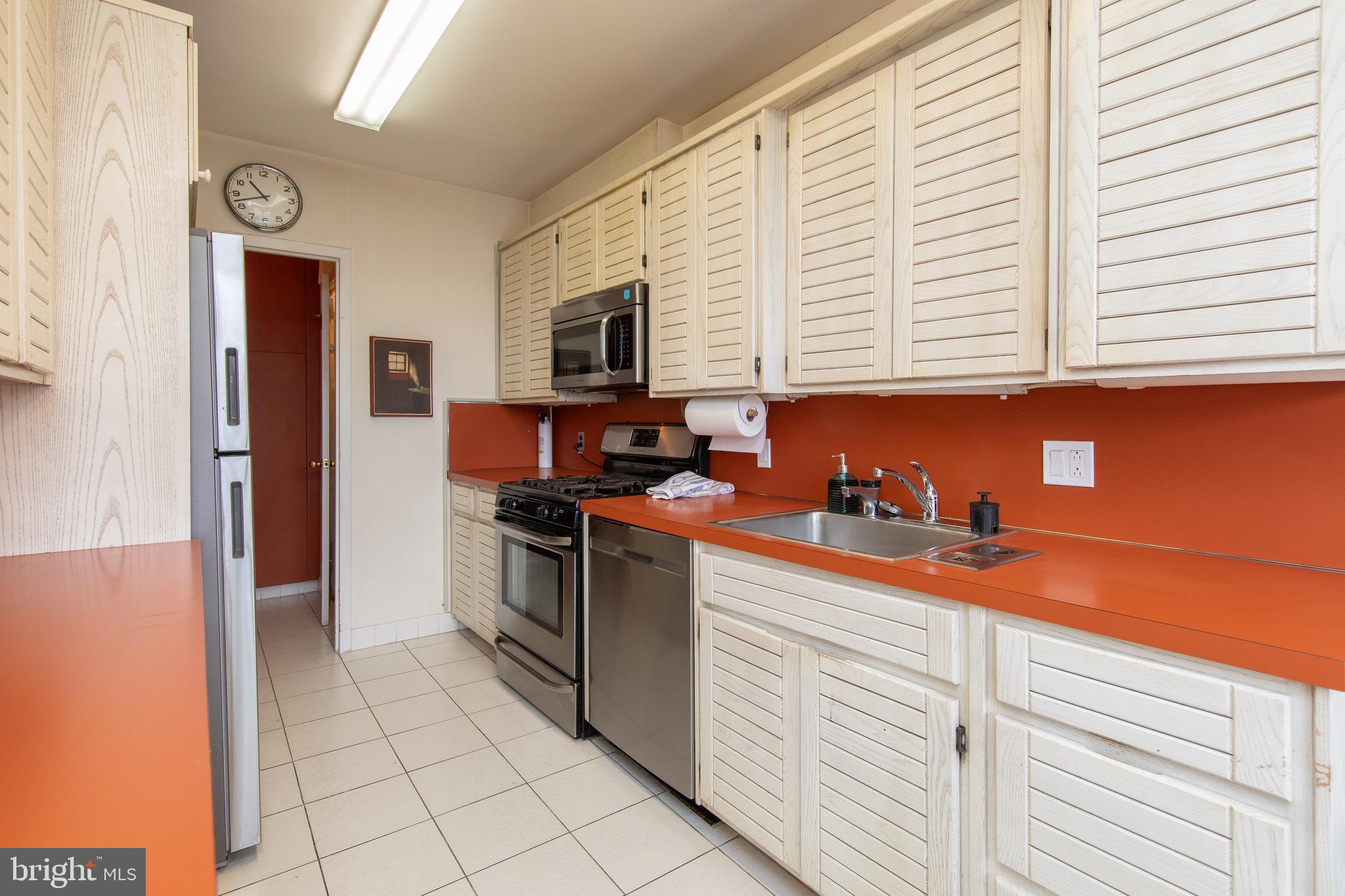 7900 Old York Road, Unit 906A Elkins Park, PA 19027 - Photo 22 of 42 a kitchen with stainless steel appliances granite countertop a refrigerator and a stove top oven