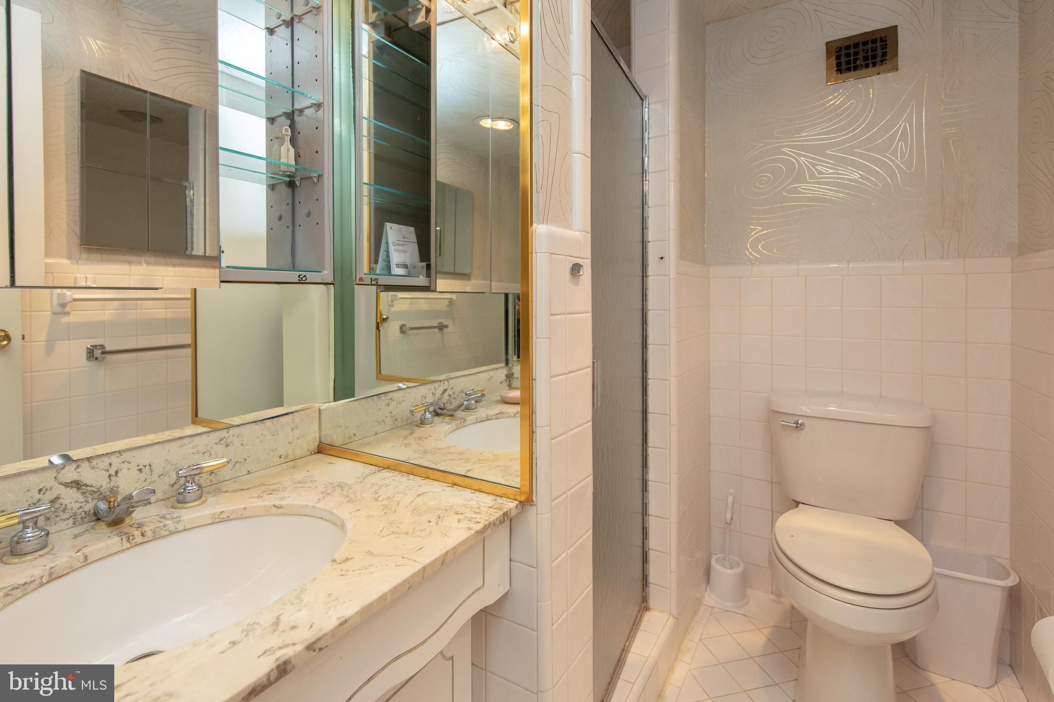 7900 Old York Road, Unit 906A Elkins Park, PA 19027 - Photo 29 of 42 a bathroom with a granite countertop sink toilet and shower