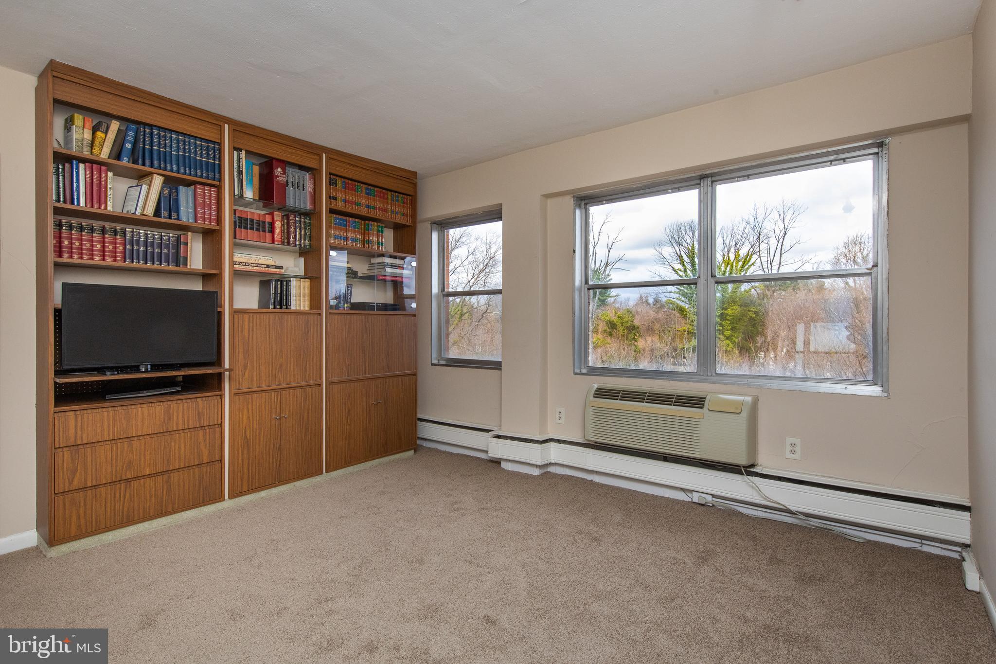 7900 Old York Road, Unit 906A Elkins Park, PA 19027 - Photo 31 of 42 a view of a livingroom with an empty space and a window