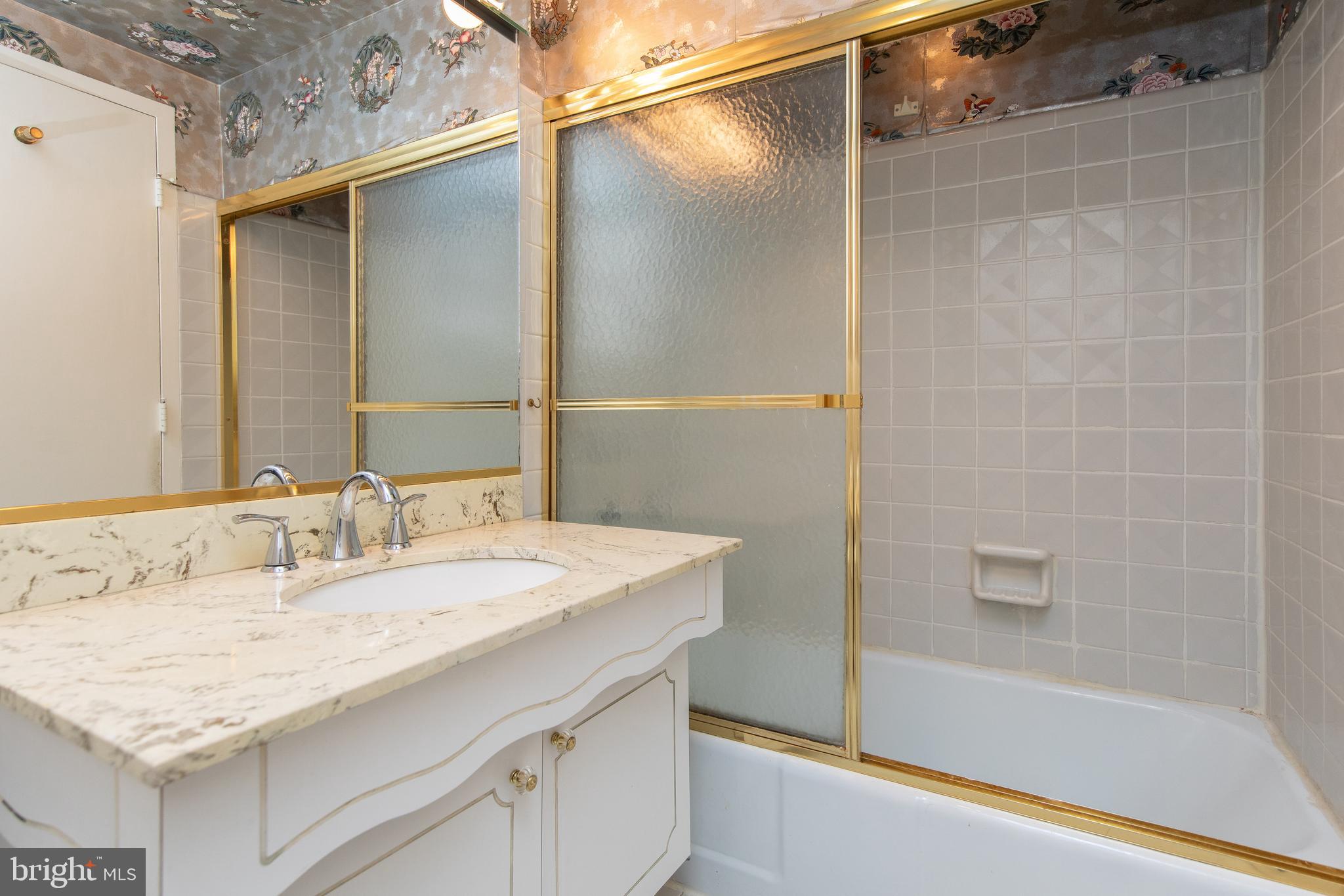7900 Old York Road, Unit 906A Elkins Park, PA 19027 - Photo 34 of 42 a bathroom with a granite countertop sink and a bathtub