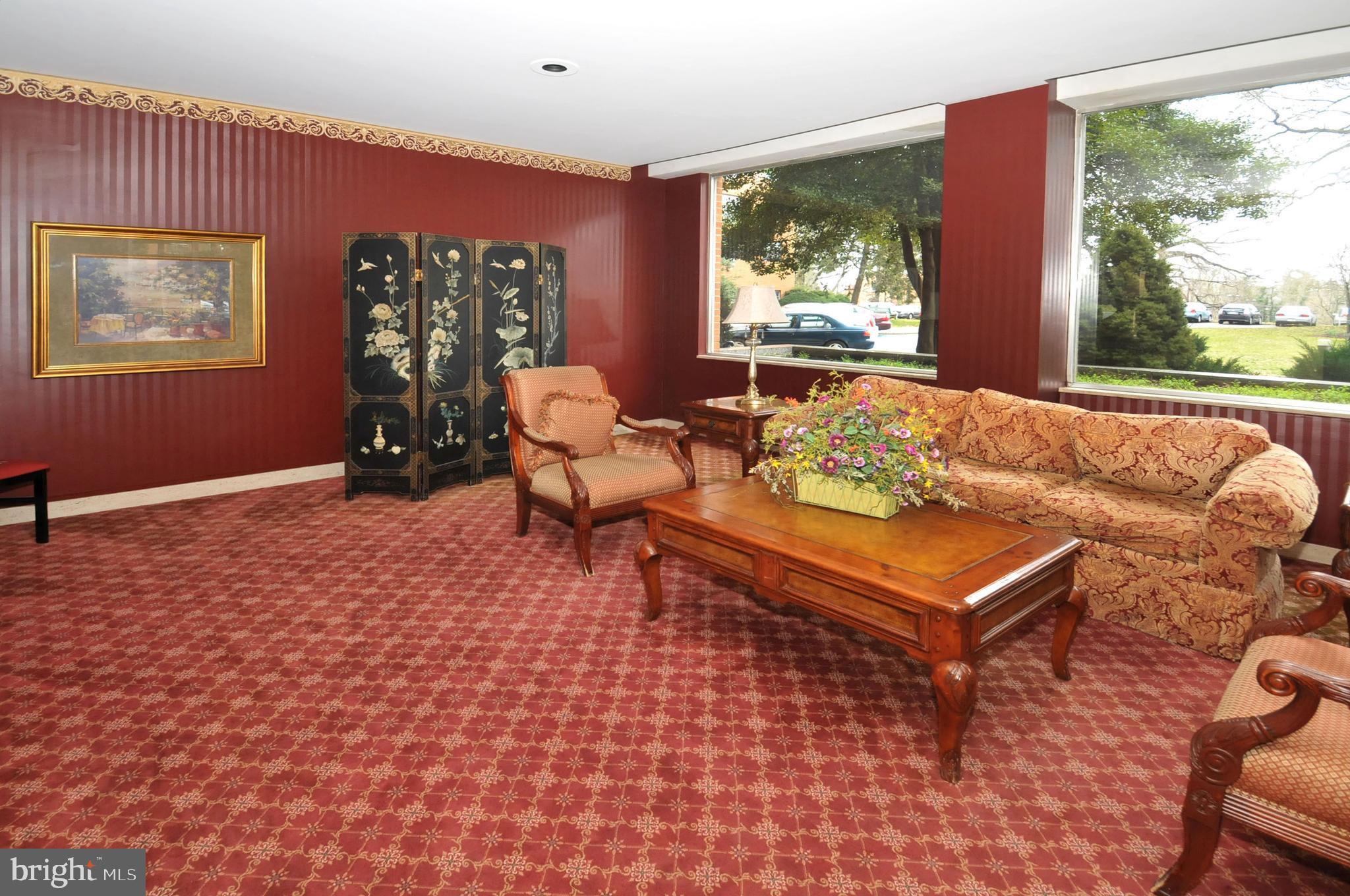 7900 Old York Road, Unit 906A Elkins Park, PA 19027 - Photo 8 of 42 a living room with furniture a window and a flat screen tv