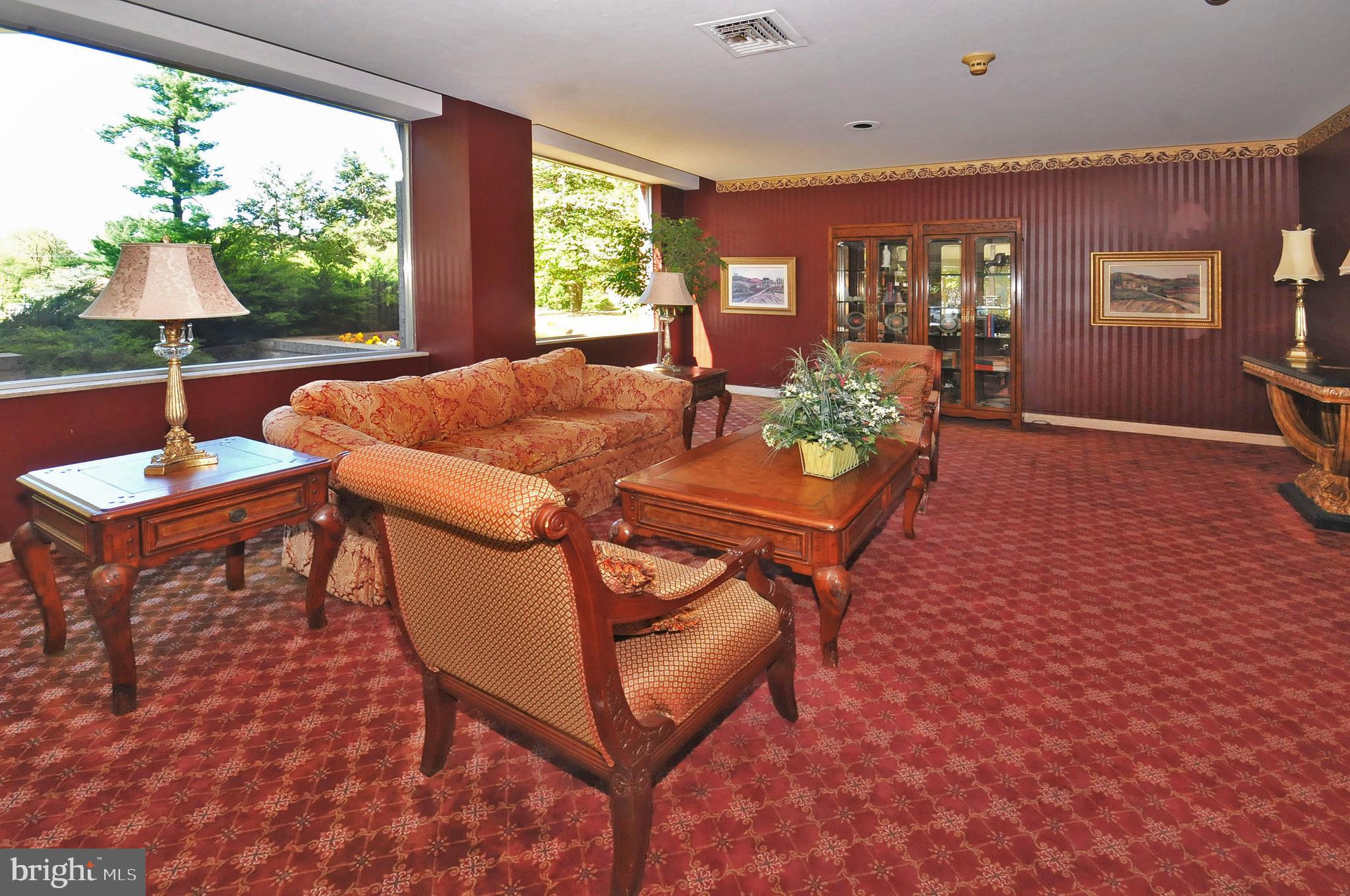 7900 Old York Road, Unit 906A Elkins Park, PA 19027 - Photo 9 of 42 a living room with furniture a window and a table