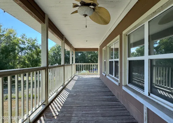 a view of a porch with wooden floor