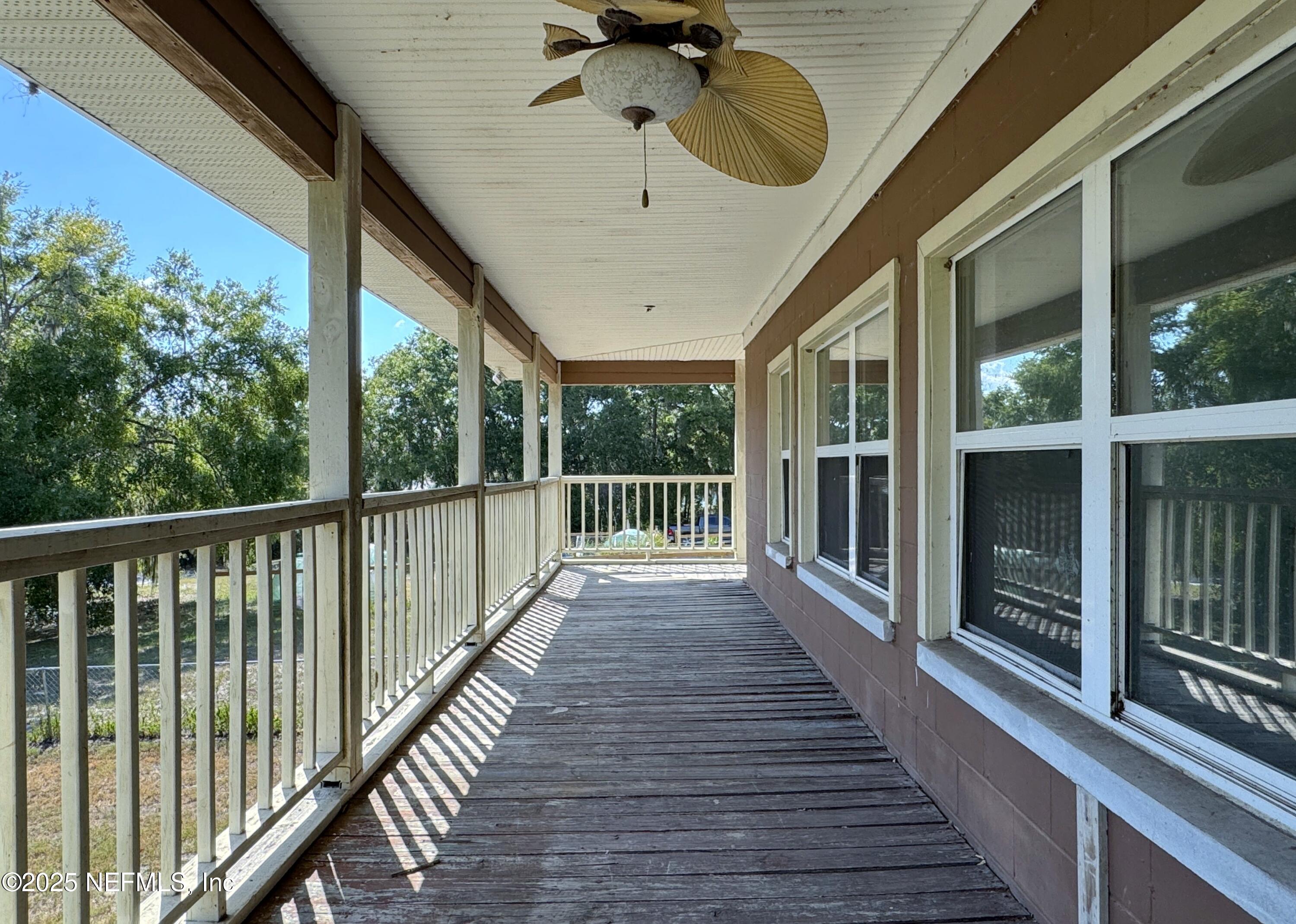5756 Southeast 55th Terrace Keystone Heights, FL 32656 - Photo 17 of 35 a view of a porch with wooden floor