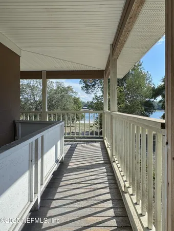 a view of a balcony with wooden floor