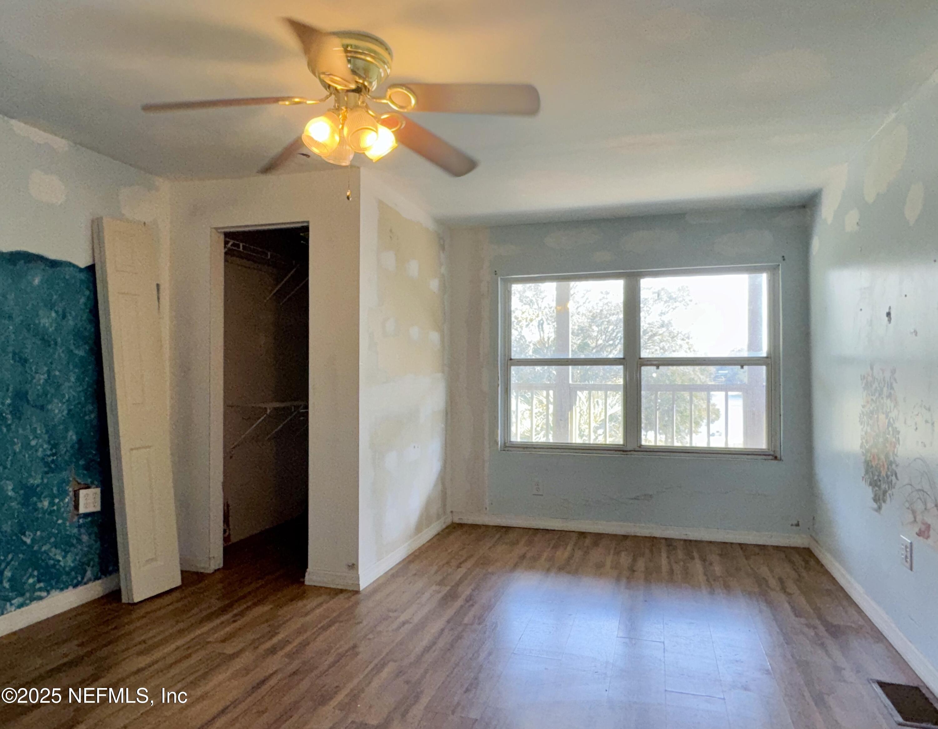 5756 Southeast 55th Terrace Keystone Heights, FL 32656 - Photo 21 of 35 wooden floor in an empty room with a window