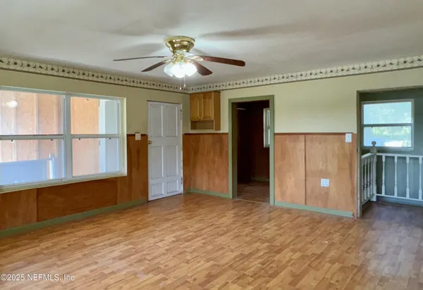 an empty room with closet and windows