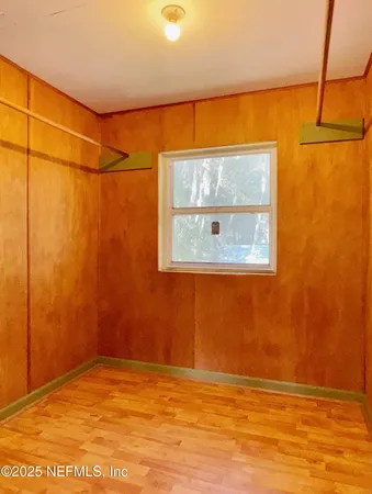 a view of a room with wooden floor and windows
