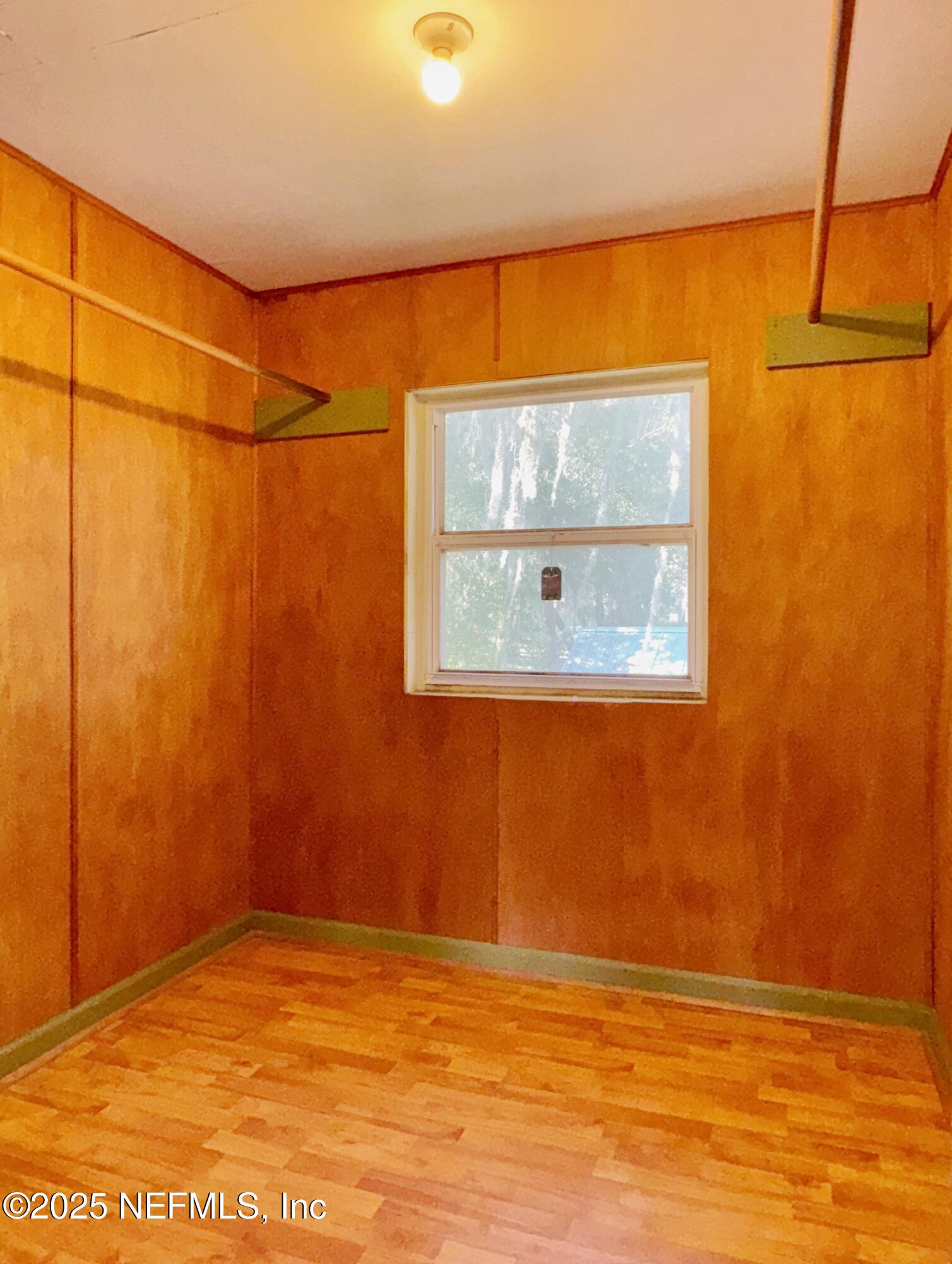 5756 Southeast 55th Terrace Keystone Heights, FL 32656 - Photo 25 of 35 a view of a room with wooden floor and windows