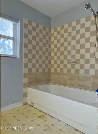 a bathroom with a bathtub and a shower