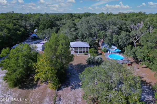 an aerial view of a house with a yard