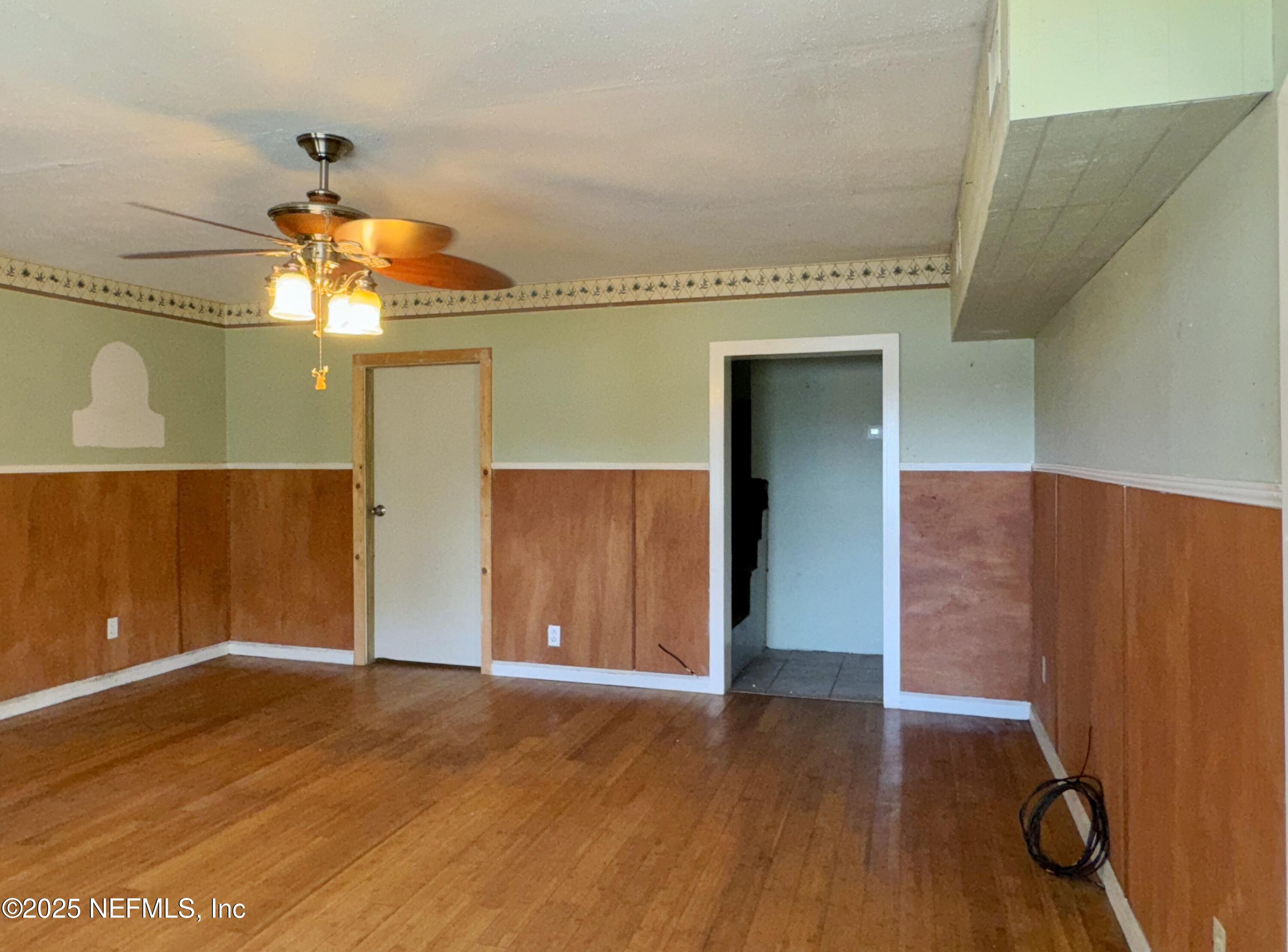 5756 Southeast 55th Terrace Keystone Heights, FL 32656 - Photo 6 of 35 a view of empty room with wooden floor